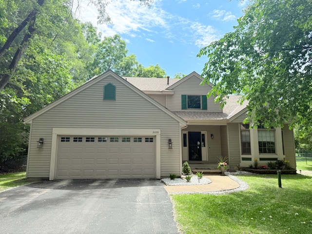 2228 Douglynn Ln, Saint Paul, MN 55119 - traditional-style house with driveway, a front lawn, a garage, and a shingled roof
