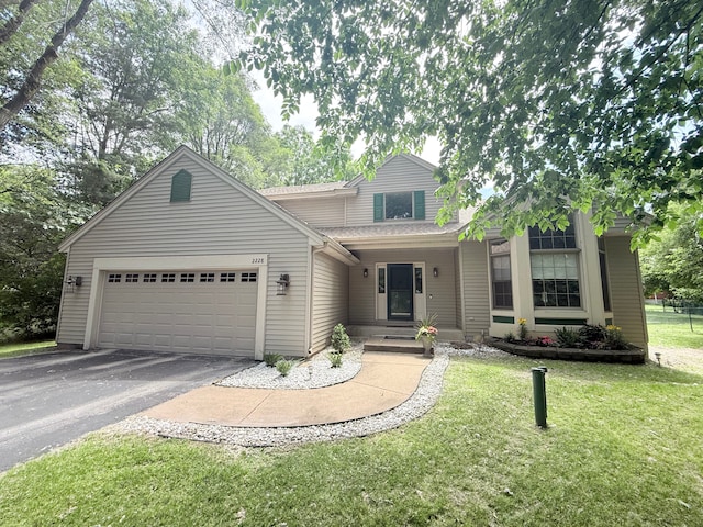 2228 Douglynn Ln, Saint Paul, MN 55119 - traditional-style home with asphalt driveway, an attached garage, a front yard, and a shingled roof