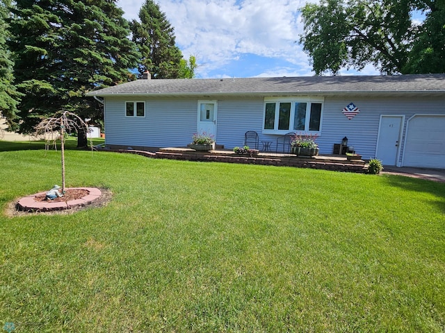 147 5th St, Felton, MN 56536 - back of house with a lawn, an attached garage, and a chimney