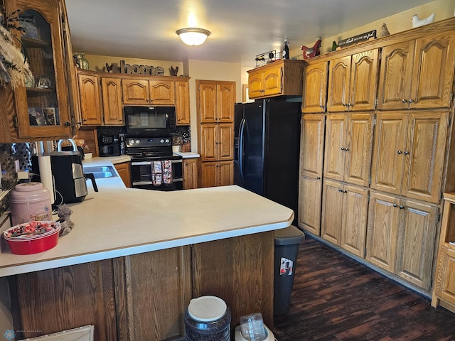 147 5th St, Felton, MN 56536 - kitchen with black appliances, light countertops, glass insert cabinets, and a peninsula