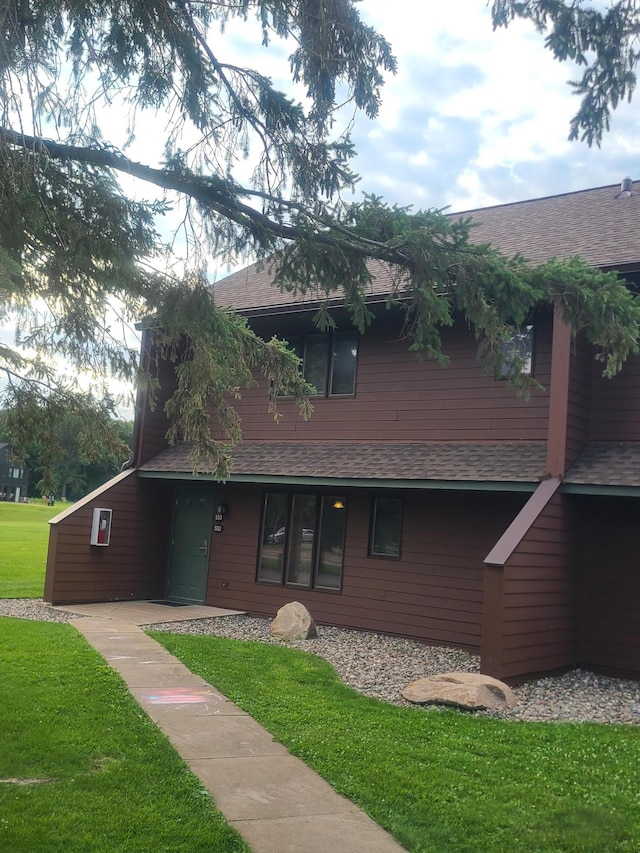 25150 Tame Fish Lake Rd Unit 552, Deerwood, MN 56444 - view of front of property featuring roof with shingles and a front lawn