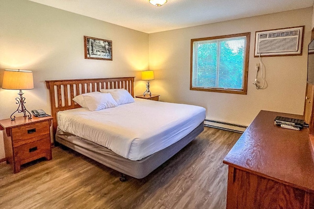 25150 Tame Fish Lake Rd Unit 552, Deerwood, MN 56444 - bedroom featuring baseboard heating, wood finished floors, and a wall mounted AC