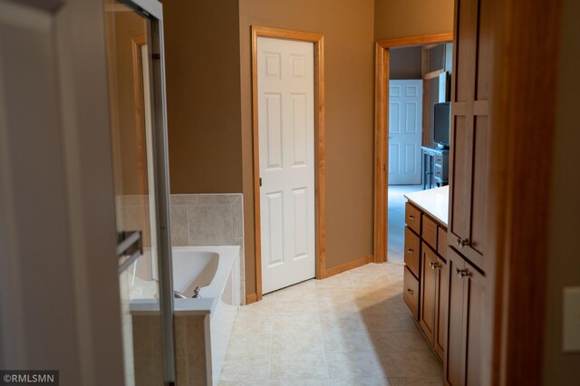 14578 Hunters Ln, Savage, MN 55378 - full bathroom with vanity, a bath, and tile patterned flooring