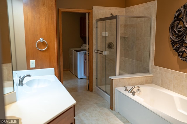 14578 Hunters Ln, Savage, MN 55378 - full bathroom featuring vanity, a stall shower, a garden tub, washing machine and dryer, and tile patterned floors