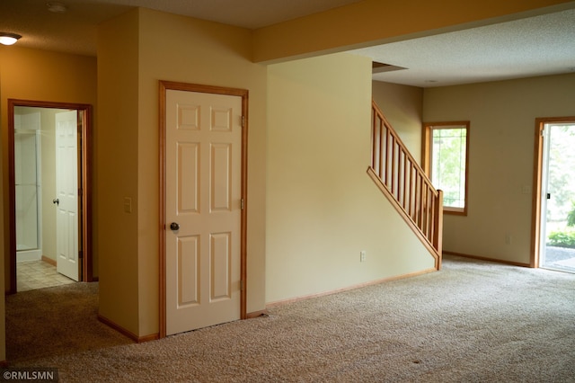 14578 Hunters Ln, Savage, MN 55378 - unfurnished living room featuring carpet floors and stairs