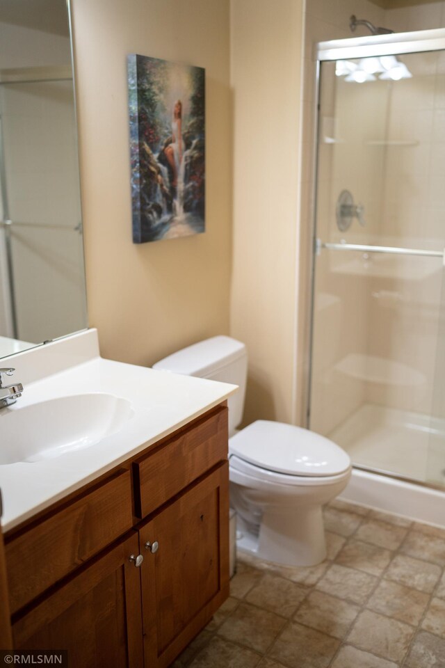 14578 Hunters Ln, Savage, MN 55378 - full bathroom featuring vanity, a shower stall, and stone finish flooring