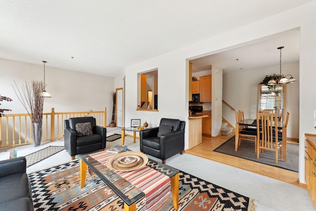 844 Coon Rapids Boulevard Extension NW, Coon Rapids, MN 55433 - living room featuring a chandelier, light colored carpet, and light wood-type flooring