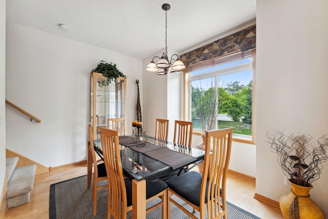 844 Coon Rapids Boulevard Extension NW, Coon Rapids, MN 55433 - dining room with light wood finished floors and a chandelier
