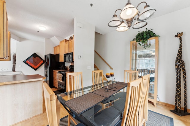 844 Coon Rapids Boulevard Extension NW, Coon Rapids, MN 55433 - dining space with light wood finished floors, a chandelier, and stairs
