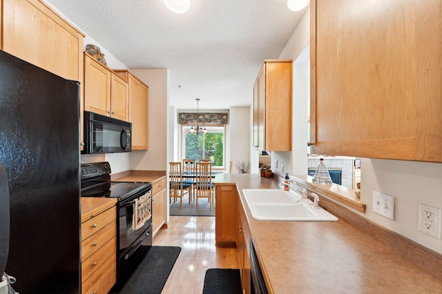 844 Coon Rapids Boulevard Extension NW, Coon Rapids, MN 55433 - kitchen featuring black appliances, light brown cabinets, light wood-style floors, light countertops, and a textured ceiling