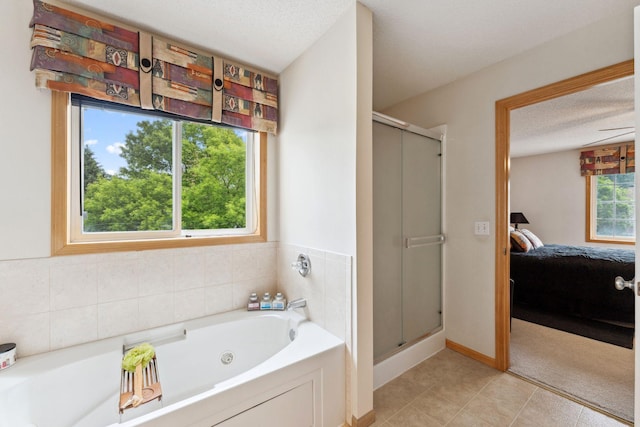 844 Coon Rapids Boulevard Extension NW, Coon Rapids, MN 55433 - bathroom with connected bathroom, a stall shower, a tub with jets, and a textured ceiling