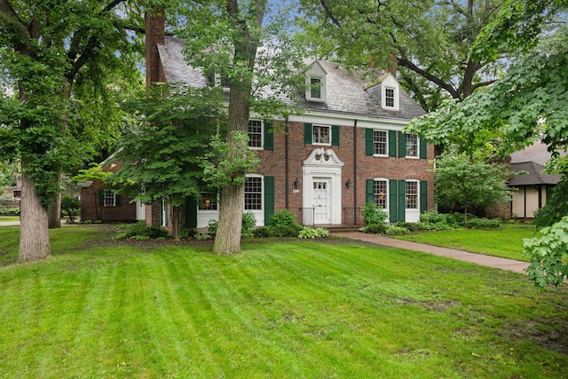 196 Mississippi River Blvd S, Saint Paul, MN 55105 - georgian-style home with brick siding, a front lawn, and a chimney