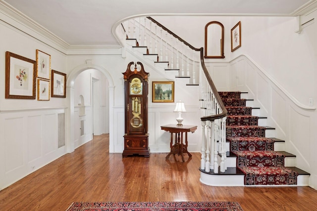 196 Mississippi River Blvd S, Saint Paul, MN 55105 - staircase with a decorative wall, arched walkways, wood finished floors, ornamental molding, and wainscoting