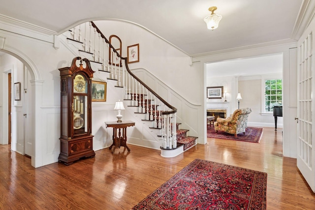 196 Mississippi River Blvd S, Saint Paul, MN 55105 - foyer featuring arched walkways, wood finished floors, stairway, and ornamental molding