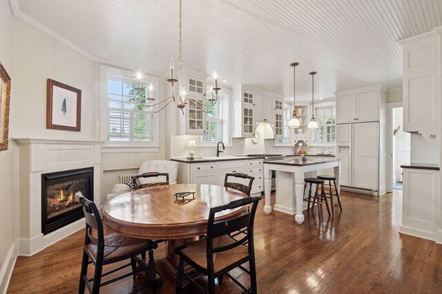 196 Mississippi River Blvd S, Saint Paul, MN 55105 - dining space featuring a glass covered fireplace, ornamental molding, dark wood-style flooring, a chandelier, and recessed lighting