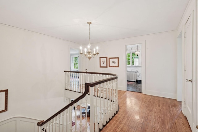 196 Mississippi River Blvd S, Saint Paul, MN 55105 - hallway featuring an upstairs landing, radiator heating unit, a chandelier, and healthy amount of natural light
