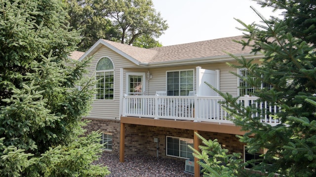 3504 Damon St Unit 38, Eau Claire, WI 54701 - back of property with brick siding, a deck, and a shingled roof