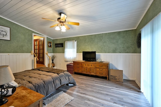 14102 Eau Claire Acres Cir, Gordon, WI 54838 - bedroom featuring a wainscoted wall, wood finished floors, a ceiling fan, vaulted ceiling, and crown molding