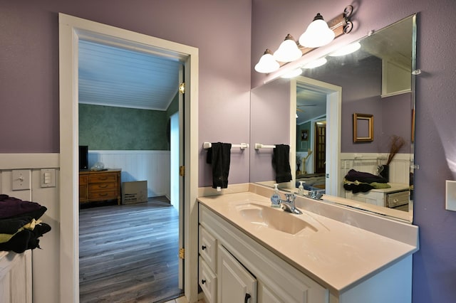 14102 Eau Claire Acres Cir, Gordon, WI 54838 - bathroom with wood finished floors, vanity, and a wainscoted wall