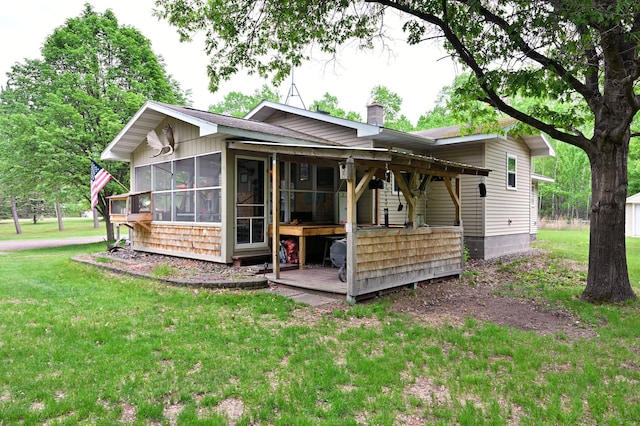 14102 Eau Claire Acres Cir, Gordon, WI 54838 - back of house featuring a chimney, a yard, and a sunroom