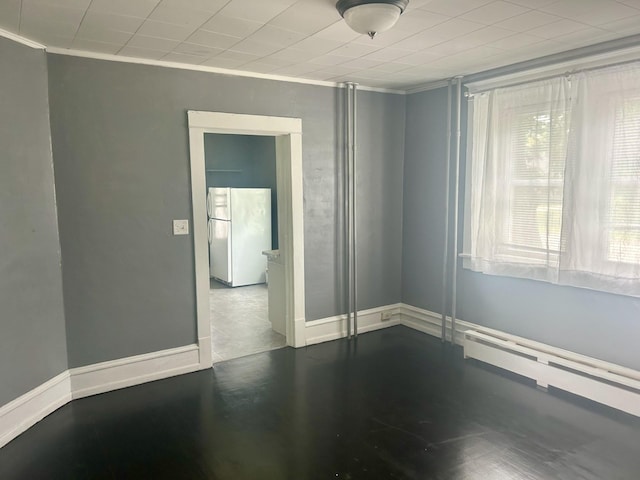 604 7th Ave E, Alexandria, MN 56308 - spare room featuring ornamental molding and a baseboard heating unit