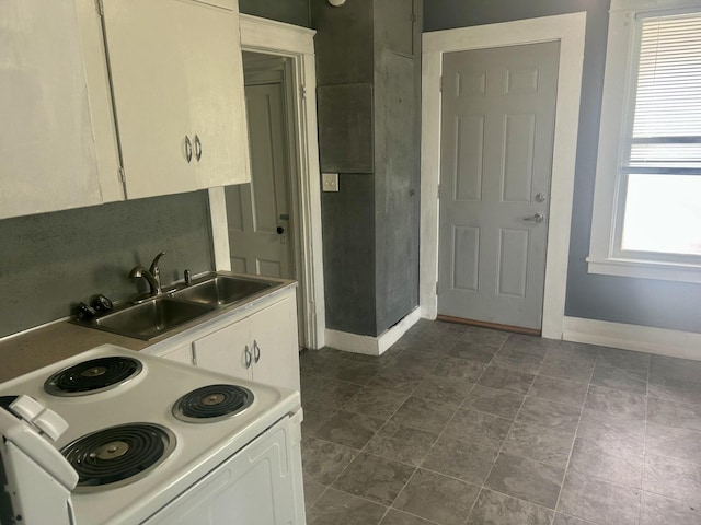 604 7th Ave E, Alexandria, MN 56308 - kitchen featuring white electric stove, white cabinets, and light countertops