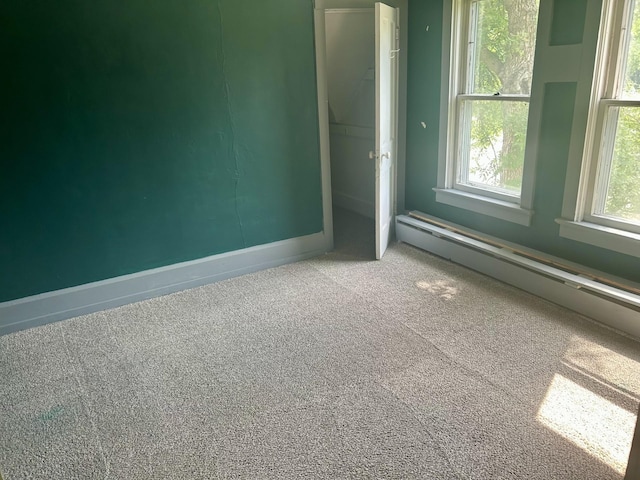 604 7th Ave E, Alexandria, MN 56308 - carpeted empty room with a baseboard radiator and baseboards