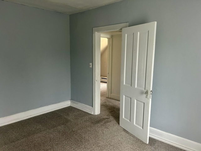 604 7th Ave E, Alexandria, MN 56308 - unfurnished room featuring carpet flooring and a baseboard heating unit