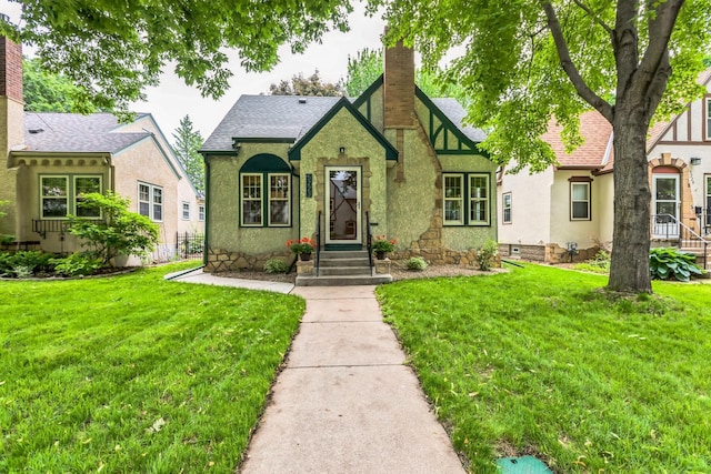 5223 15th Ave S, Minneapolis, MN 55417 - english style home with a chimney, a front yard, and stucco siding