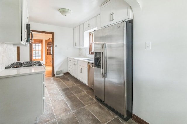 5223 15th Ave S, Minneapolis, MN 55417 - kitchen with stainless steel appliances, tasteful backsplash, light countertops, and white cabinets