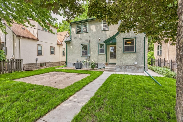 5223 15th Ave S, Minneapolis, MN 55417 - rear view of house with stucco siding, entry steps, and a patio area