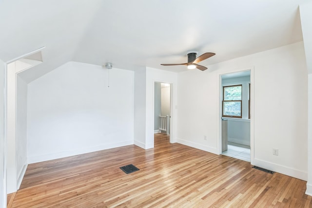 5223 15th Ave S, Minneapolis, MN 55417 - unfurnished room with light wood-style floors, a ceiling fan, and vaulted ceiling