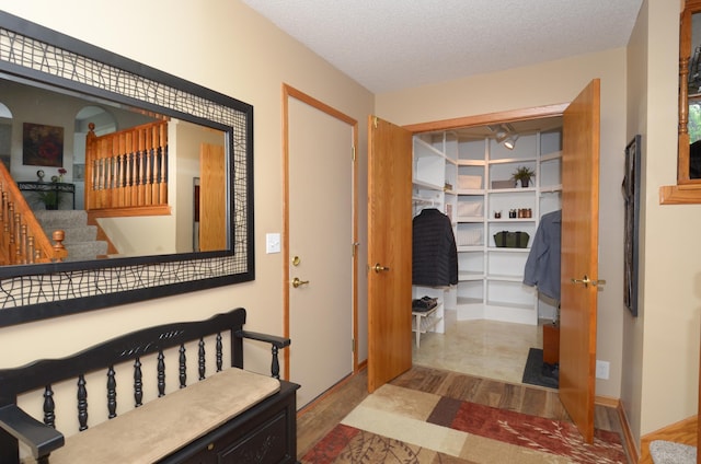 6441 Arthur St NE, Fridley, MN 55432 - corridor featuring wood finished floors, stairs, and a textured ceiling