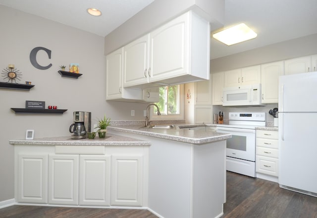6441 Arthur St NE, Fridley, MN 55432 - kitchen featuring white appliances, a peninsula, white cabinets, dark wood-type flooring, and recessed lighting