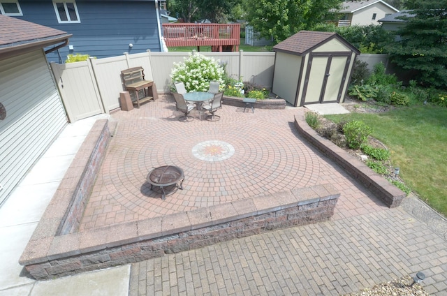 6441 Arthur St NE, Fridley, MN 55432 - fenced backyard with a storage shed, a patio area, a fire pit, and outdoor dining space