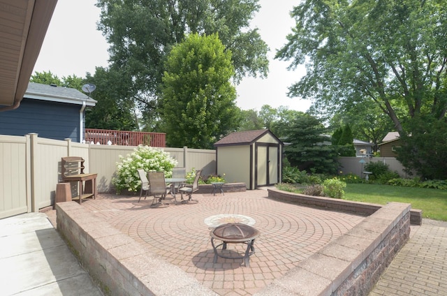 6441 Arthur St NE, Fridley, MN 55432 - fenced backyard featuring a fire pit, a patio, and a shed