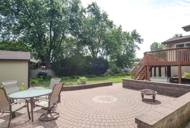 6441 Arthur St NE, Fridley, MN 55432 - view of patio / terrace featuring a fire pit, outdoor dining area, stairway, and a wooden deck