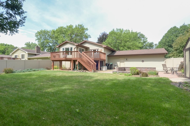 6441 Arthur St NE, Fridley, MN 55432 - rear view of house featuring a wooden deck, stairs, a fenced backyard, and a patio area