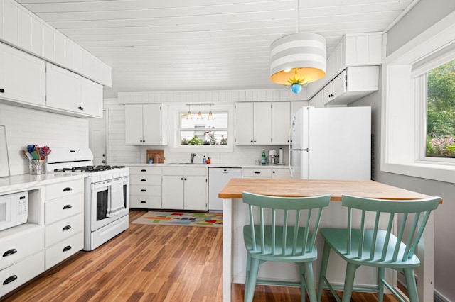 611 11th Ave, Grand Rapids, MN 55744 - kitchen with white appliances, wood finished floors, a kitchen breakfast bar, white cabinets, and wooden ceiling