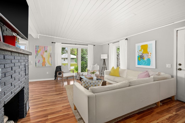 611 11th Ave, Grand Rapids, MN 55744 - living room featuring wood ceiling, a fireplace, and light wood finished floors