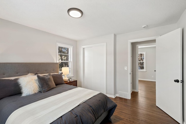 401 Plymouth Rd, Minnetonka, MN 55305 - bedroom featuring dark wood finished floors and a closet