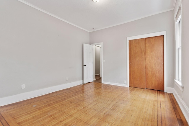 3208 Pleasant Ave, Minneapolis, MN 55408 - unfurnished bedroom with ornamental molding, wood-type flooring, and a closet