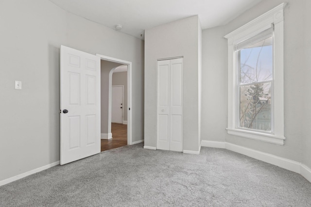 3208 Pleasant Ave, Minneapolis, MN 55408 - unfurnished bedroom with carpet floors, arched walkways, and a closet