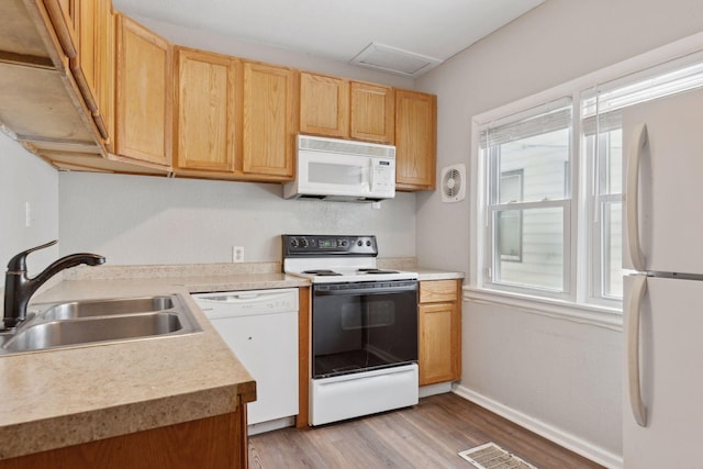 3208 Pleasant Ave, Minneapolis, MN 55408 - kitchen featuring white appliances, light wood finished floors, light countertops, and light brown cabinets