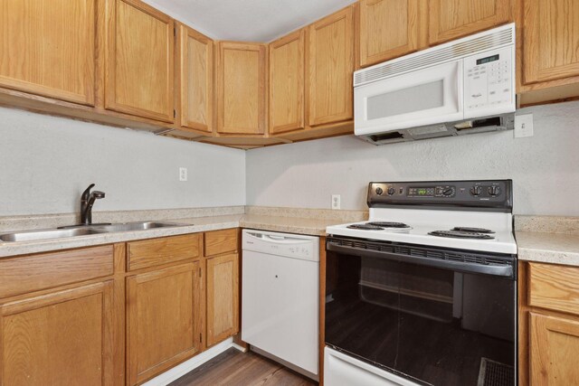 3208 Pleasant Ave, Minneapolis, MN 55408 - kitchen featuring white appliances, light countertops, and dark wood finished floors