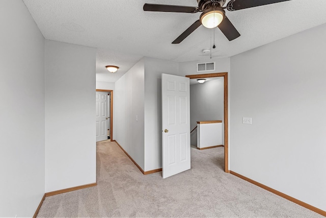 1587 Liberty St, Shakopee, MN 55379 - empty room with light carpet, a ceiling fan, a textured ceiling, and a smoke detector