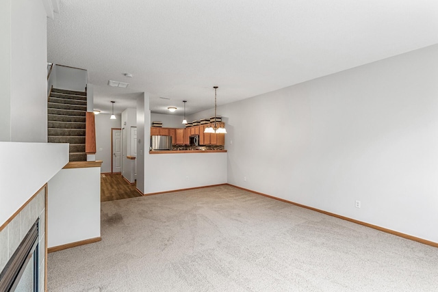 1587 Liberty St, Shakopee, MN 55379 - unfurnished living room with carpet, stairs, and a fireplace