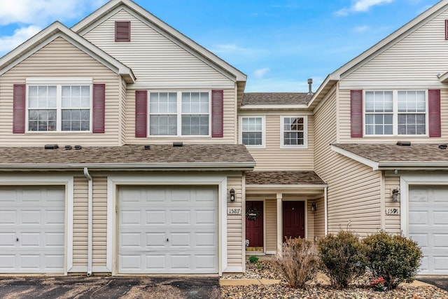 1587 Liberty St, Shakopee, MN 55379 - townhome / multi-family property with an attached garage, roof with shingles, and asphalt driveway