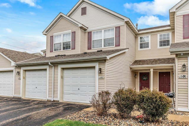 1587 Liberty St, Shakopee, MN 55379 - townhome / multi-family property featuring asphalt driveway, roof with shingles, and a garage
