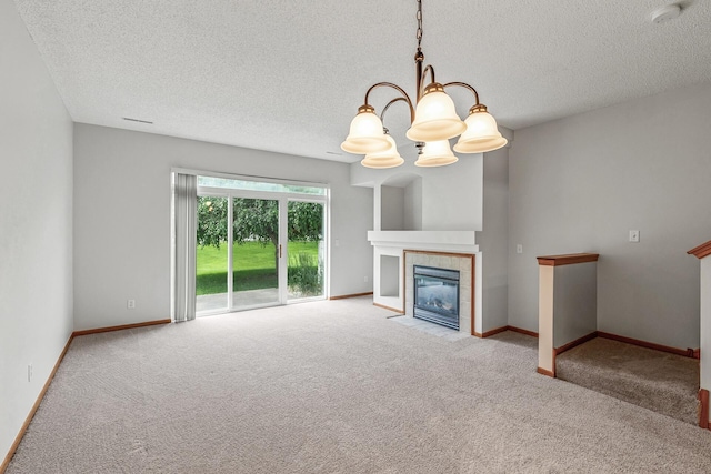 1587 Liberty St, Shakopee, MN 55379 - unfurnished living room featuring carpet flooring, a chandelier, a textured ceiling, and a tiled fireplace